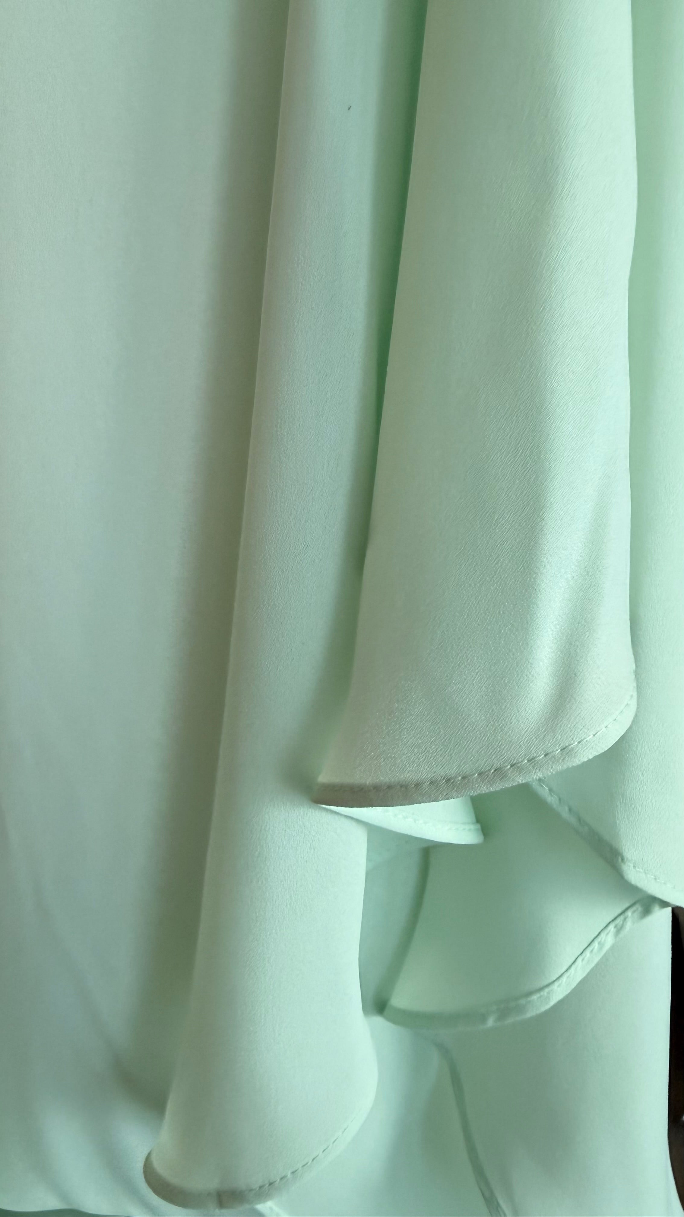 Close-up of light green fabric with a soft texture