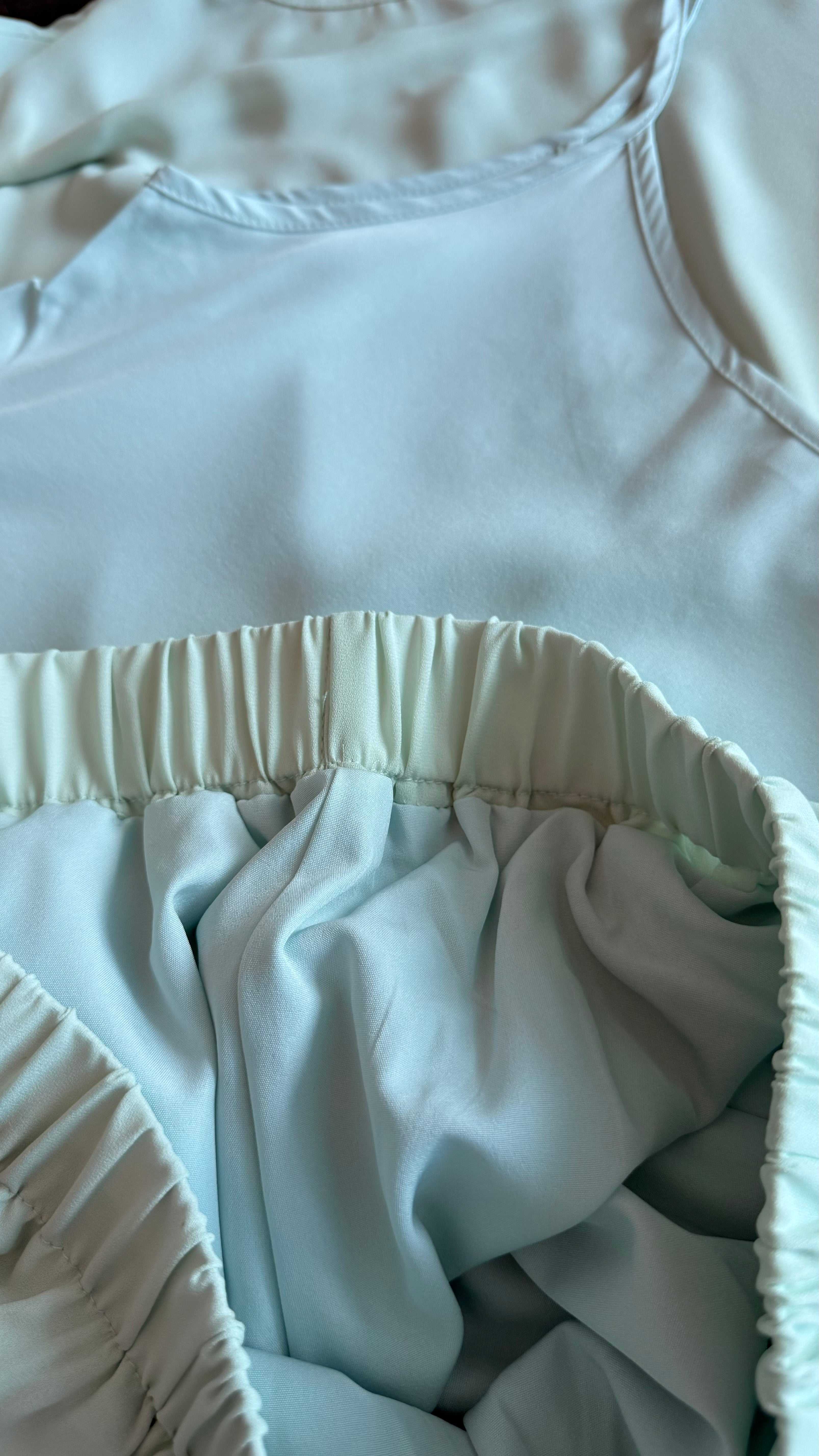 Light blue fabric with a focus on the waistband and bottom hem.
