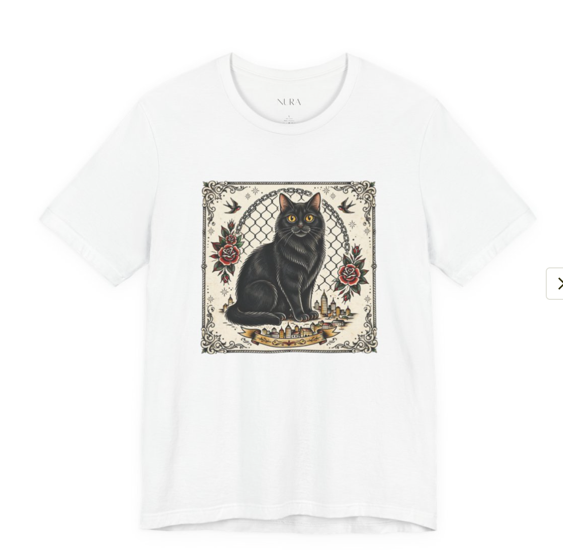 A white short-sleeve crewneck t-shirt featuring a central graphic print of a black cat sitting in front of a chain-link fence, decorated with red roses and a gold crown.