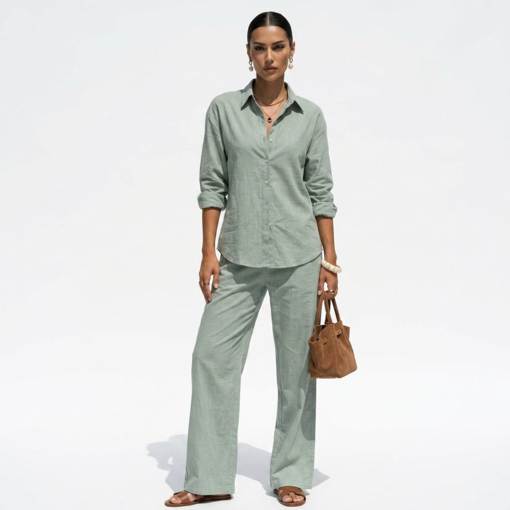 Woman wearing a light green outfit with a brown bag on a white background