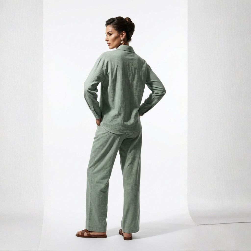 Woman wearing a green pajama set on a white background