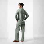 Woman wearing a green pajama set on a white background