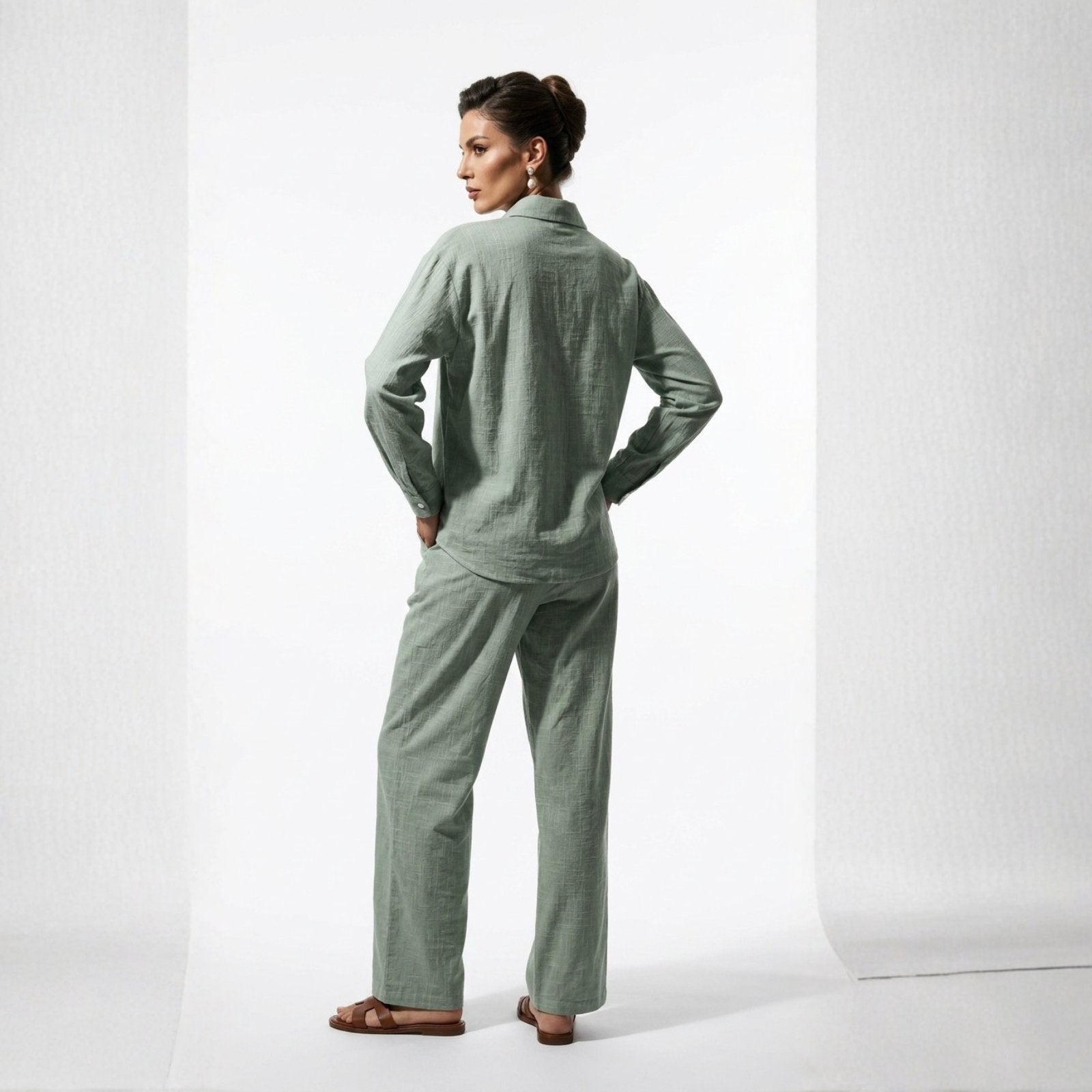 Woman wearing a green pajama set on a white background