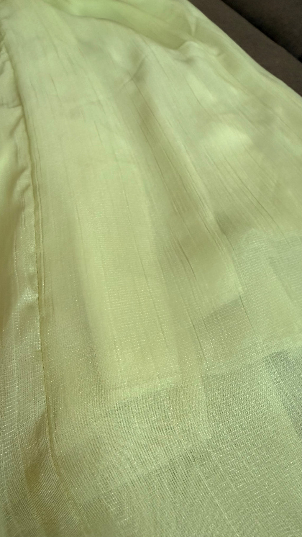 Close-up of light green fabric with a subtle pattern