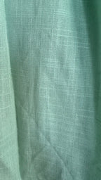 Close-up of green fabric with a textured pattern