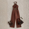 Brown jumpsuit with accessories on a textured beige background