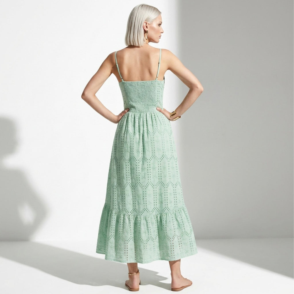 Woman wearing a green dress with a white background