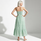Woman wearing a green dress with a white background