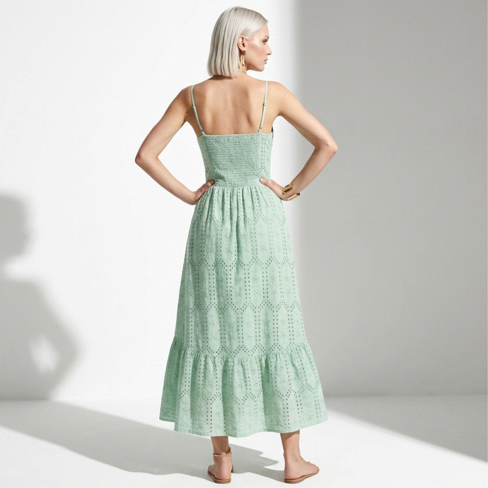 Woman wearing a green dress with a white background