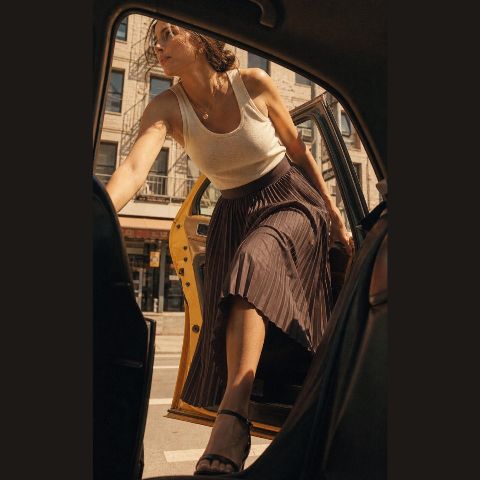 Woman getting out of a taxi on a city street