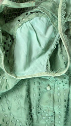Close-up of a green lace garment with a white interior lining.