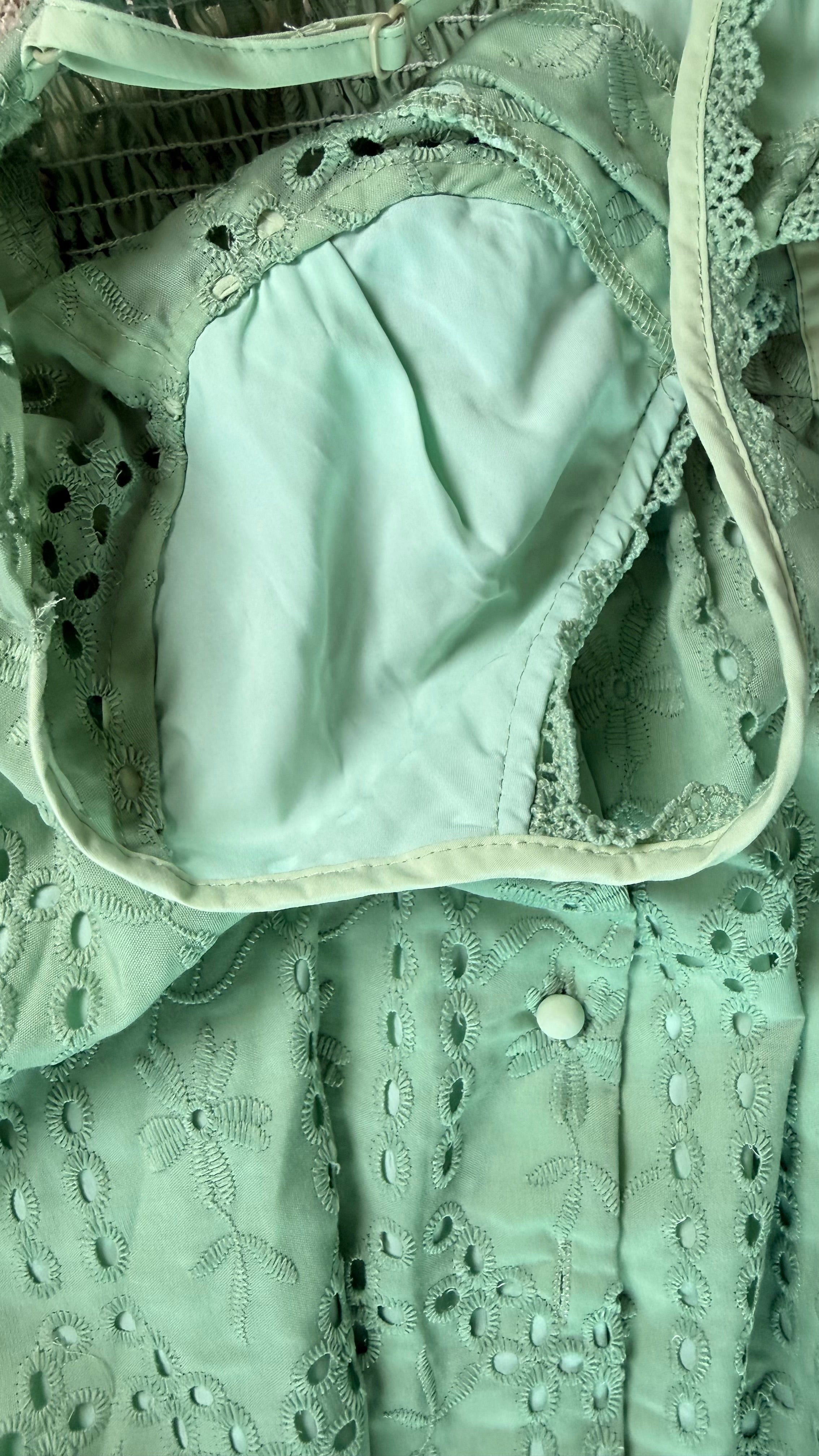 Close-up of a green lace garment with a white interior lining.