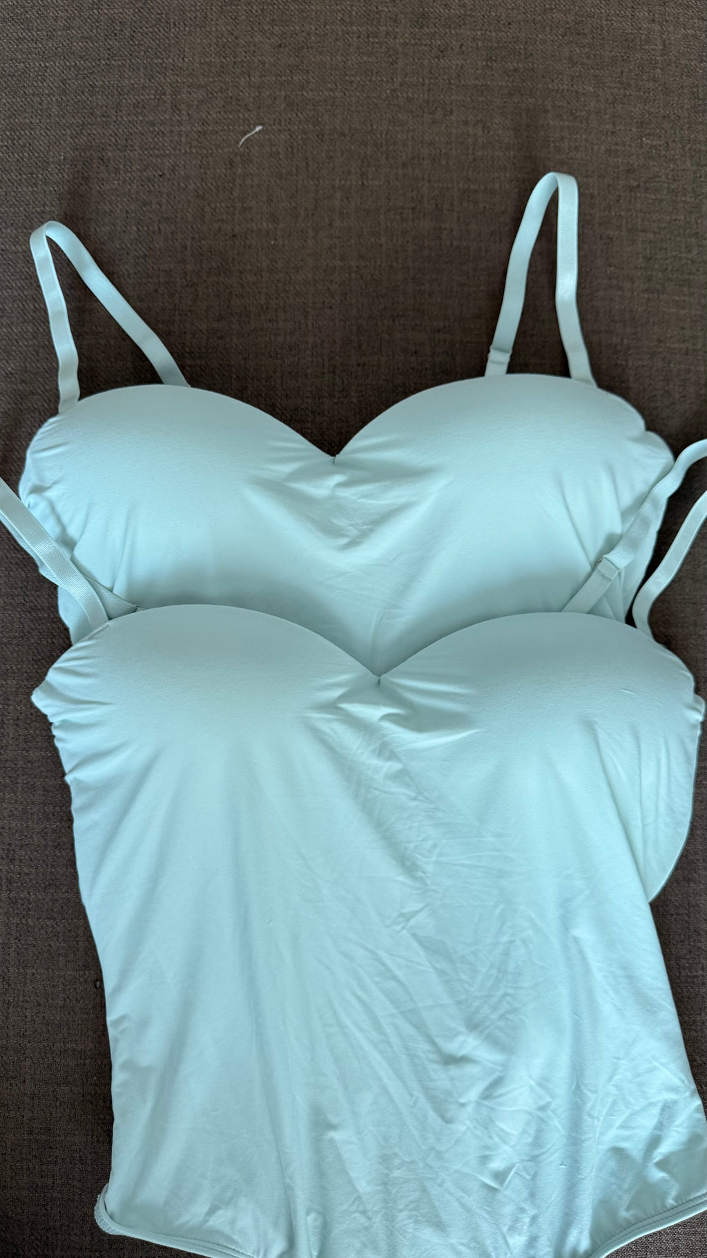 Light green bodysuitson a brown background