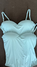 Light green bodysuitson a brown background