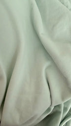 Close-up of light green fabric texture