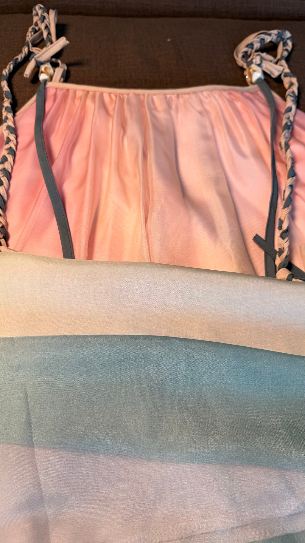 Pink top with leopard print straps on a brown surface
