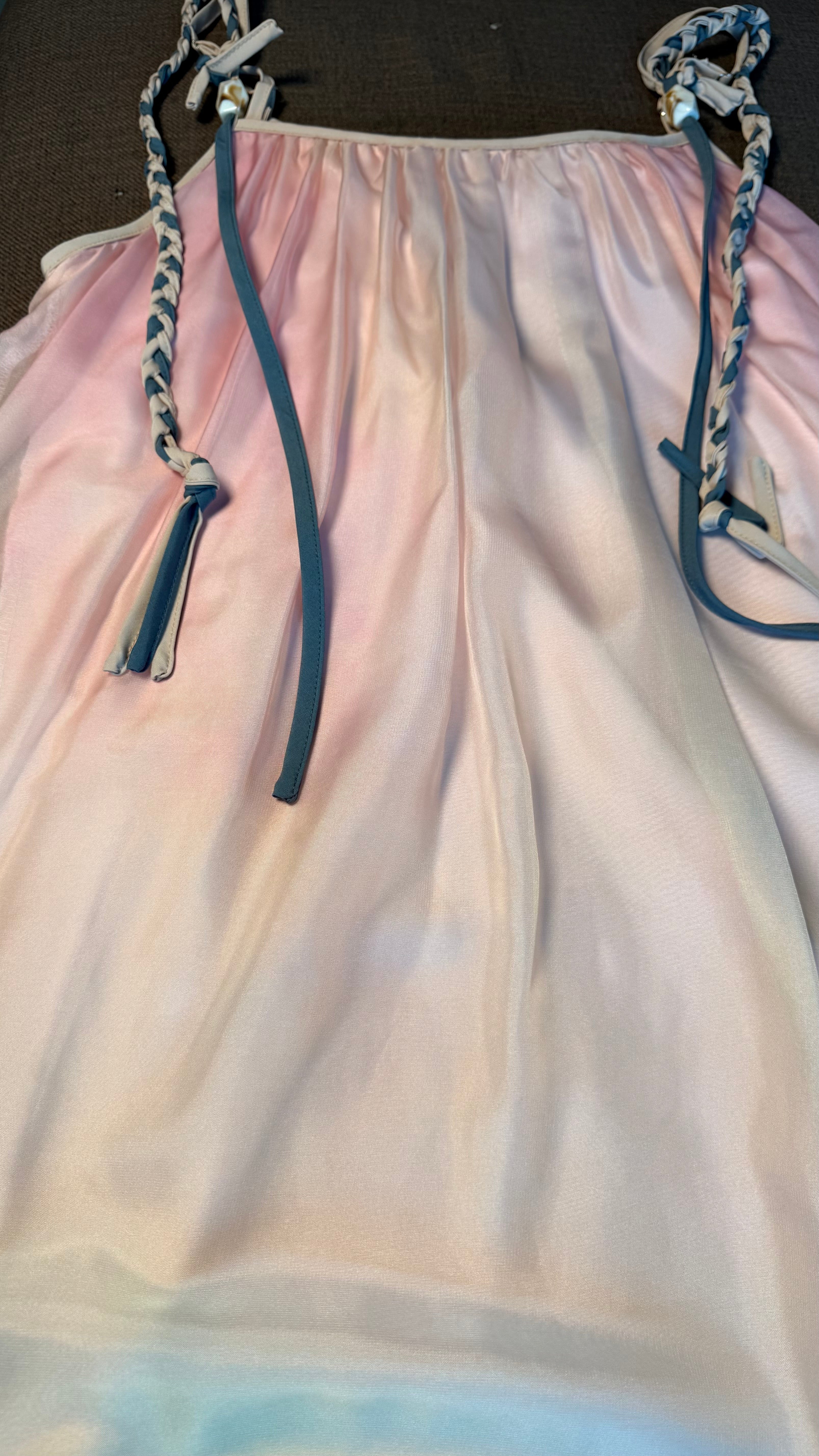 Light pink dress with thin straps on a dark background