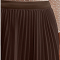 Brown pleated skirt with a textured background