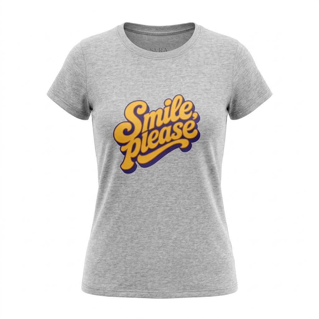 A women's heather gray short-sleeve t-shirt featuring a retro-style graphic on the chest that reads 'Smile, please' in yellow with a purple shadow effect.